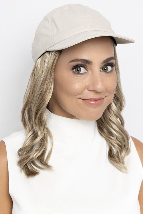 beige baseball hat with below the shoulder gray blond hair